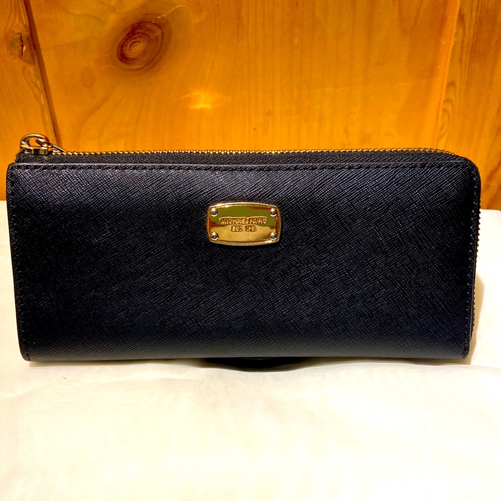 Michael Kors black coated canvas zip wallet.